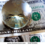 stock-photo-george-washington-closeup-eye-under-cristal-globe-on-the-one-dollar-note-558793081